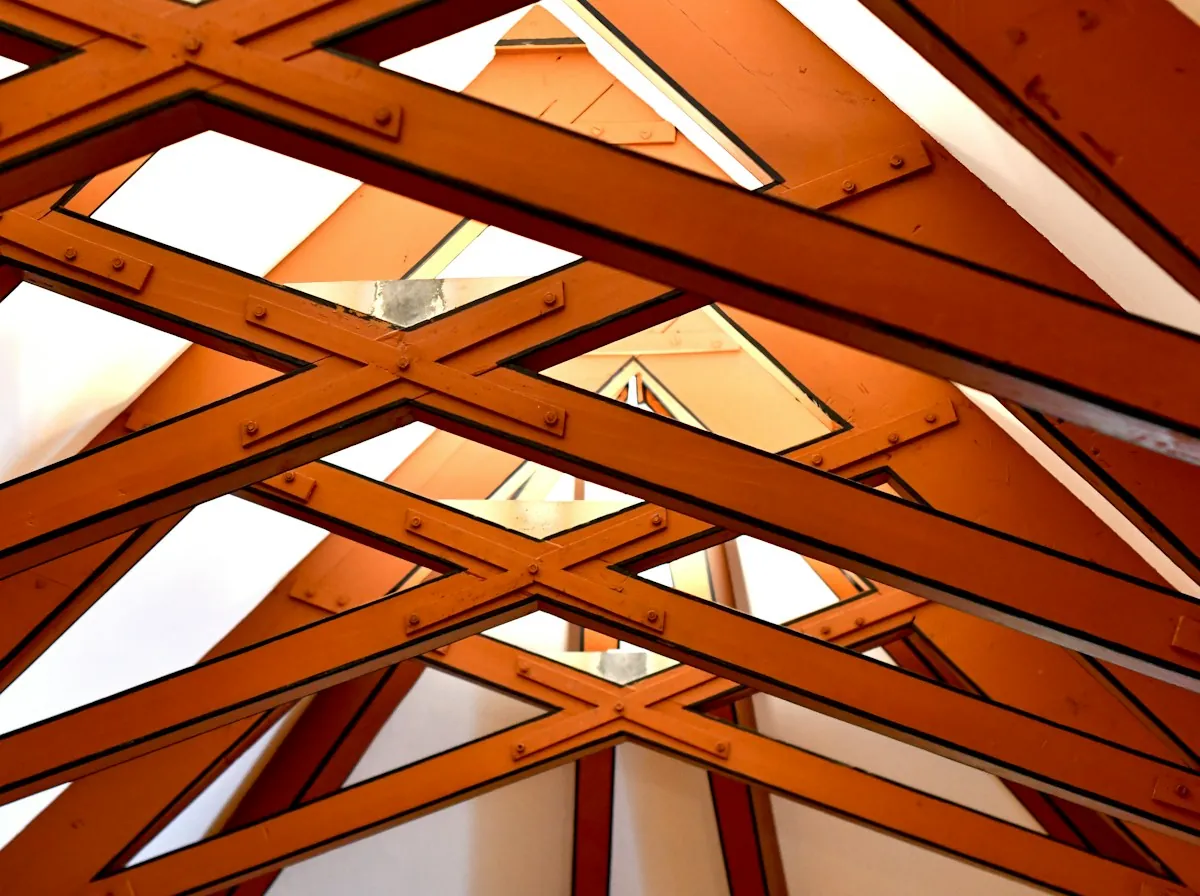 Roof Replacement in El Monte — exposed timber trusses and roof windows in an attic